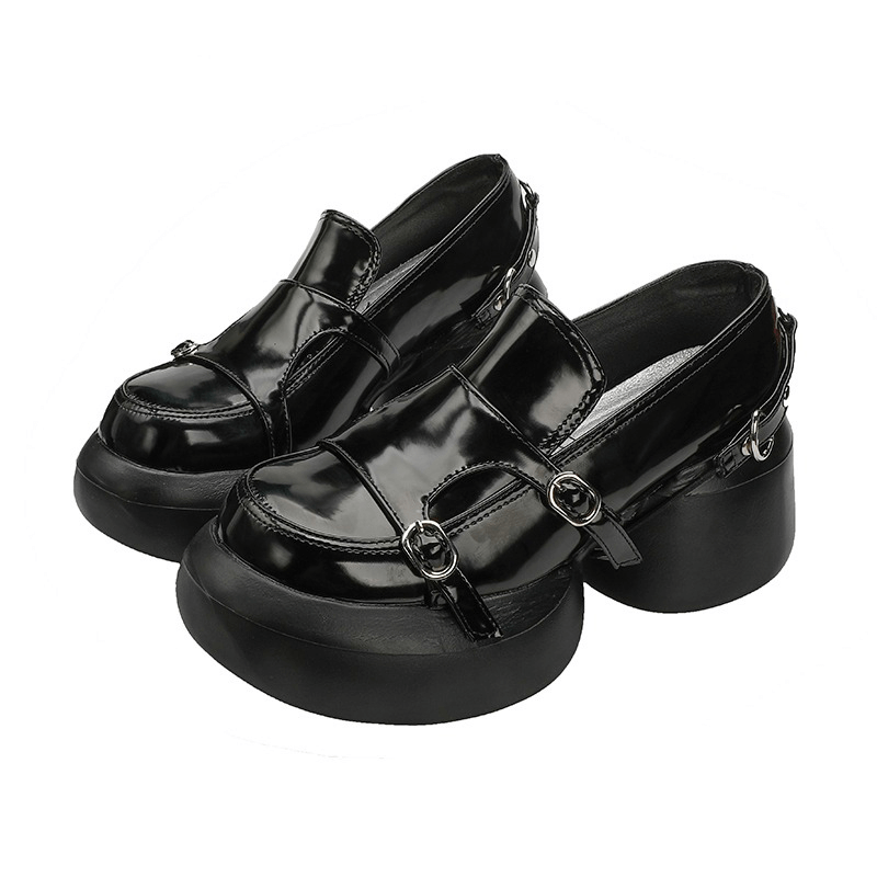 Stylish black patent leather loafers with buckles, featuring a chunky heel in punk fashion.