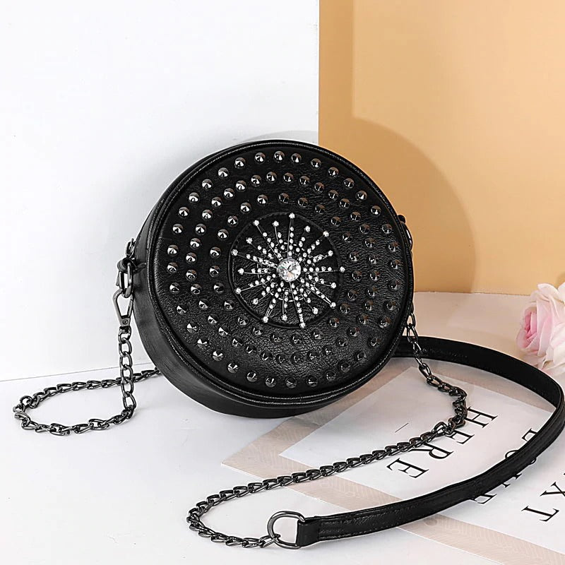 Gothic round handbag with diamond embellishments and a chain strap, perfect for a stylish rock look.