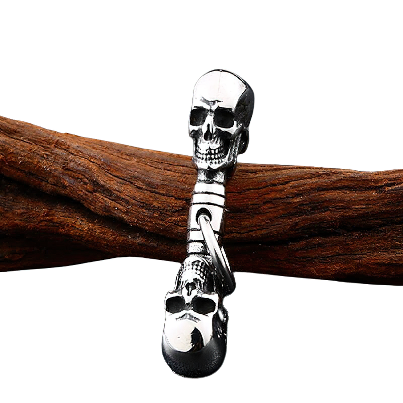 Double-headed skull pendant on wooden background, unisex vintage stainless steel necklace for rock style lovers.