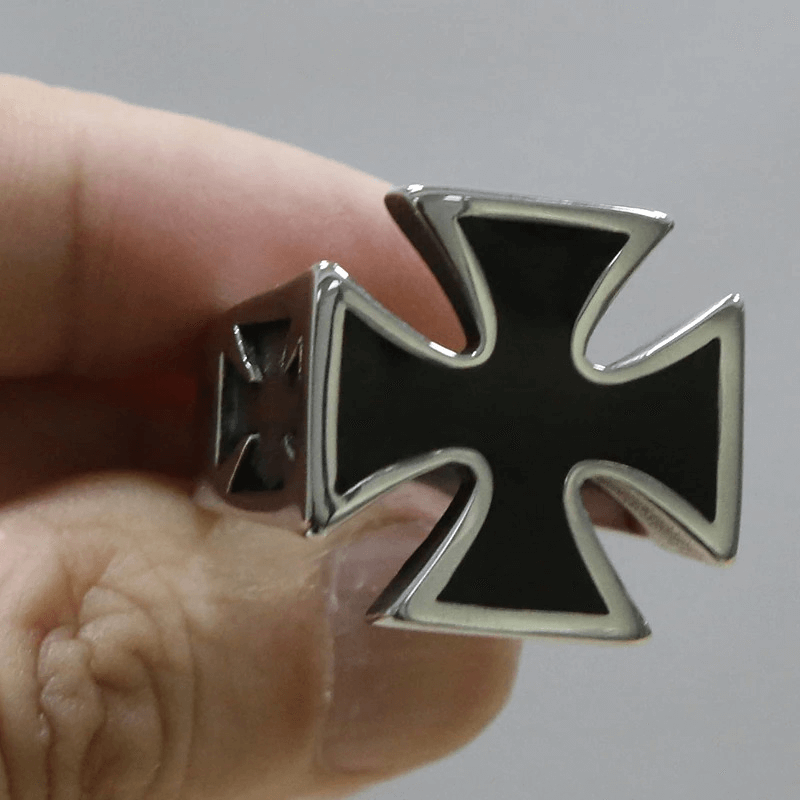 Close-up of a unique titanium Celtic cross ring, bold biker jewelry in black and stainless steel.
