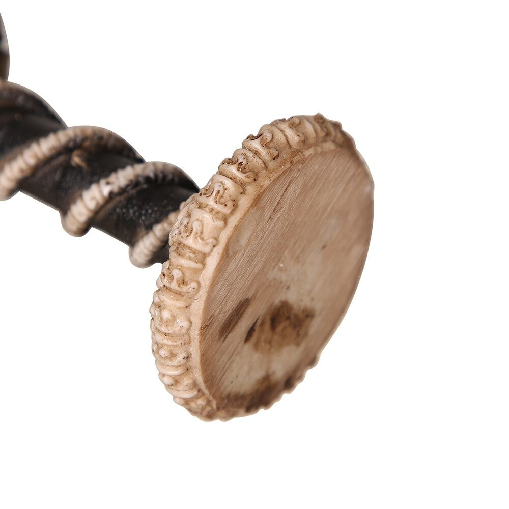 Close-up of the base of a dragon bone stainless steel wine glass with ornate detailing and gothic design elements.