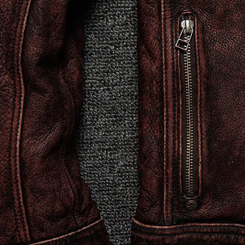Close-up of a durable brown leather biker jacket featuring a stylish zipper detail.