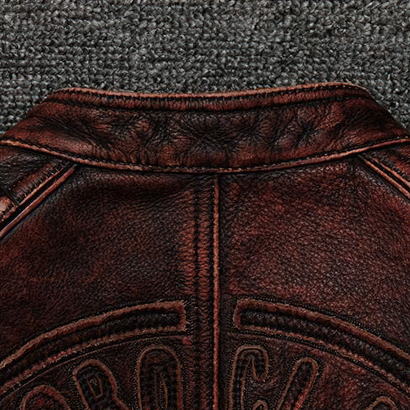 Close-up of the collar and stitching on a vintage brown biker jacket made from genuine leather.