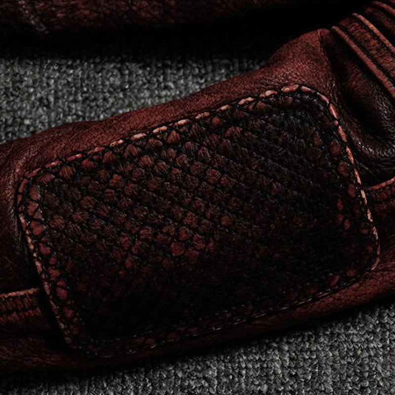 Close-up of the textured leather detail on a vintage brown biker jacket, showcasing genuine craftsmanship and style.