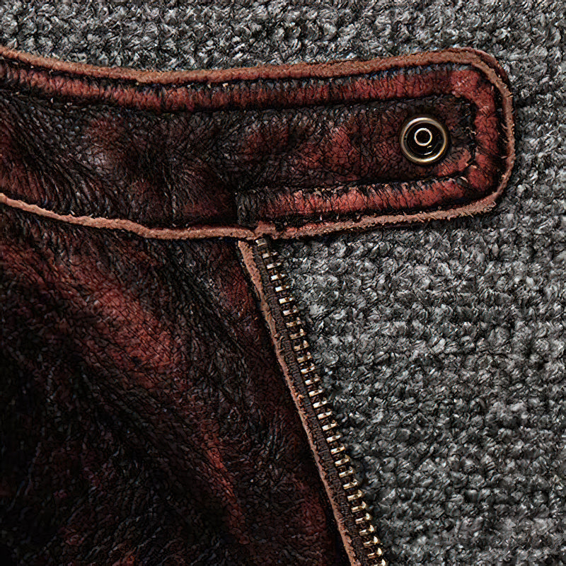 Close-up of the durable brown leather biker jacket showcasing zipper and textured fabric details.