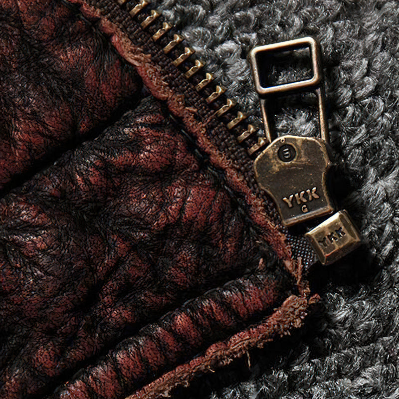 Close-up of stylish brown leather jacket zipper detail, showcasing high-quality materials and craftsmanship.