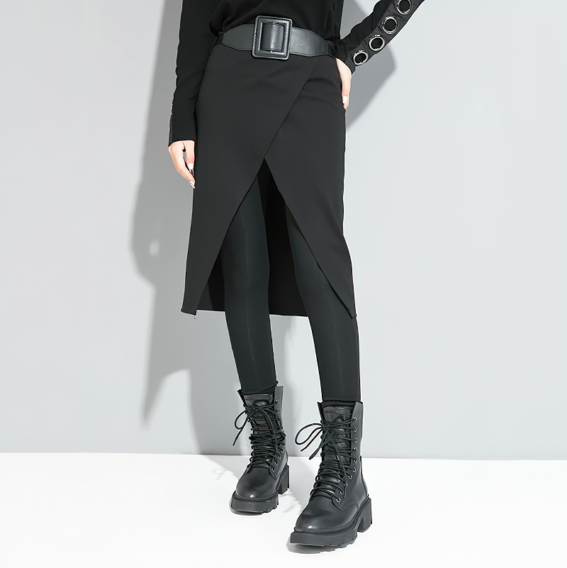 Trendy black high waist women's trousers with ankle length and a decorative belt, paired with stylish black boots.