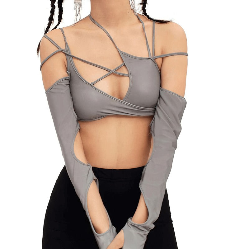 Stylish woman in a sexy cut out long sleeve crop top with asymmetrical design in grey, showcasing alternative fashion.