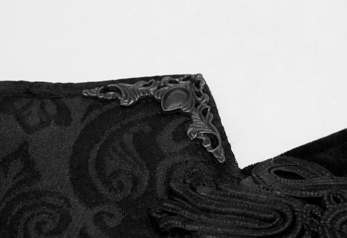 Close-up of elegant black corset detail featuring ornate brocade and stylish lace-up design, perfect for gothic fashion.