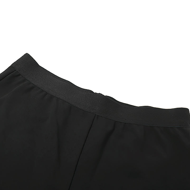 Close-up of the waistband of a sleek black halter dress showcasing its elegant design and stylish cut.