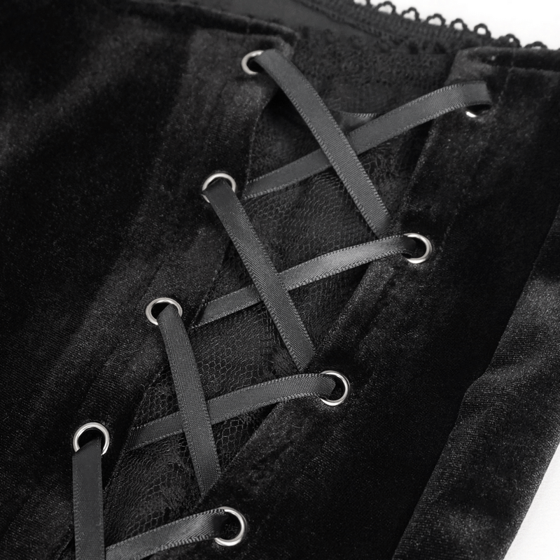 Close-up of black velvet flared pants showcasing gothic lace-up detailing and elegant design.