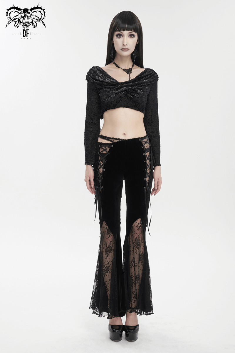 Stylish model wearing elegant black velvet flared pants with gothic lace-up details and matching top.