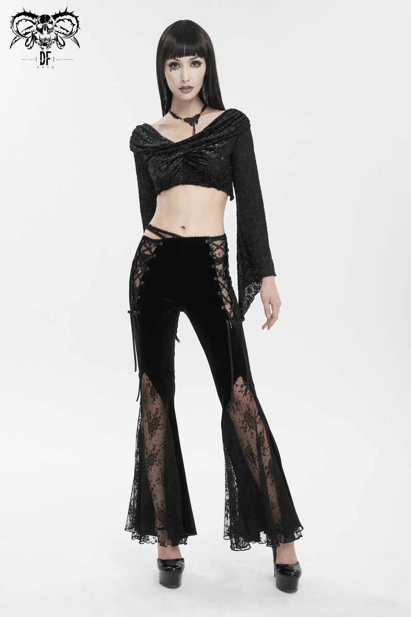 Stylish model wearing elegant black velvet flared pants with gothic lace-up details and matching crop top.