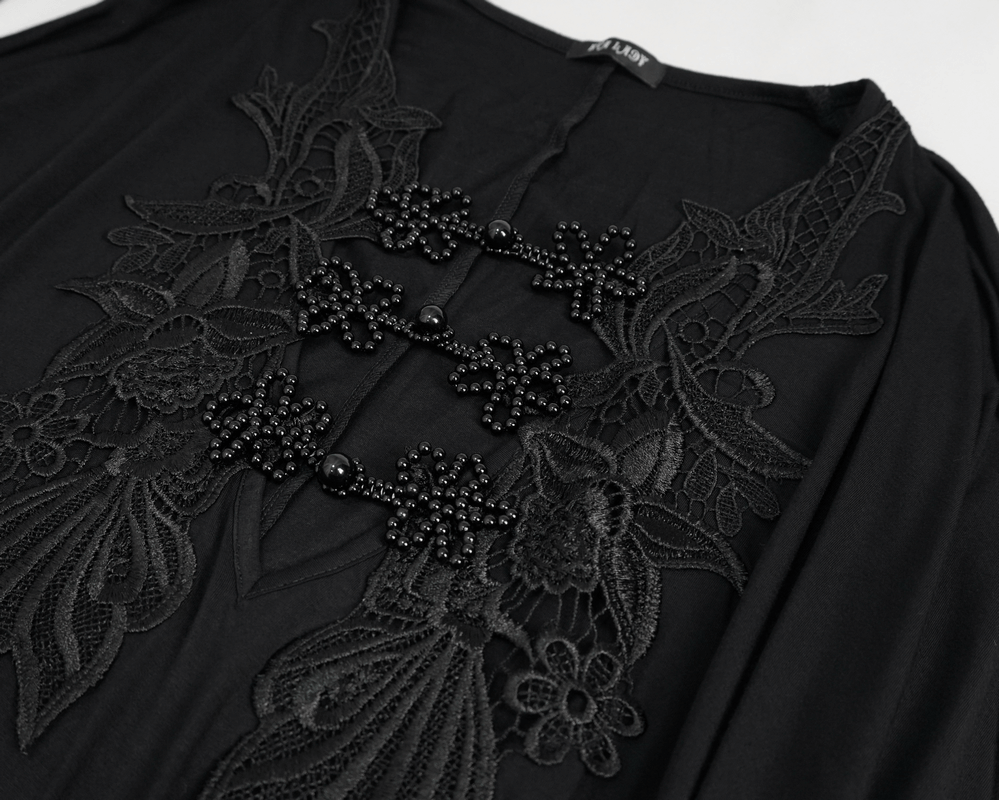 Elegant black lace detail with floral embellishments on a deep V-neck dress.