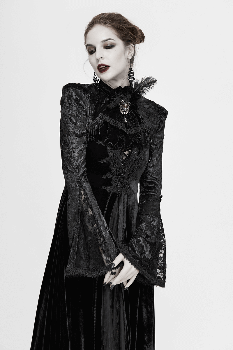 Gothic style woman in elegant black lace dress with feather and brooch, showcasing alternative fashion.