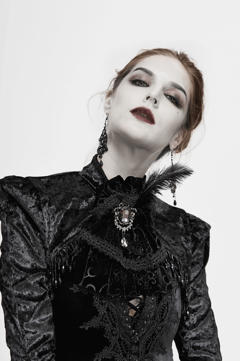 Model showcasing an elegant gothic outfit with a lace necktie, feather accent, and dramatic makeup.