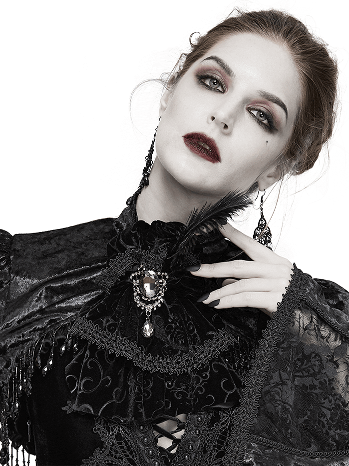 Elegant woman in gothic attire wearing a lace necktie, showcasing a silver brooch and feather accessory.