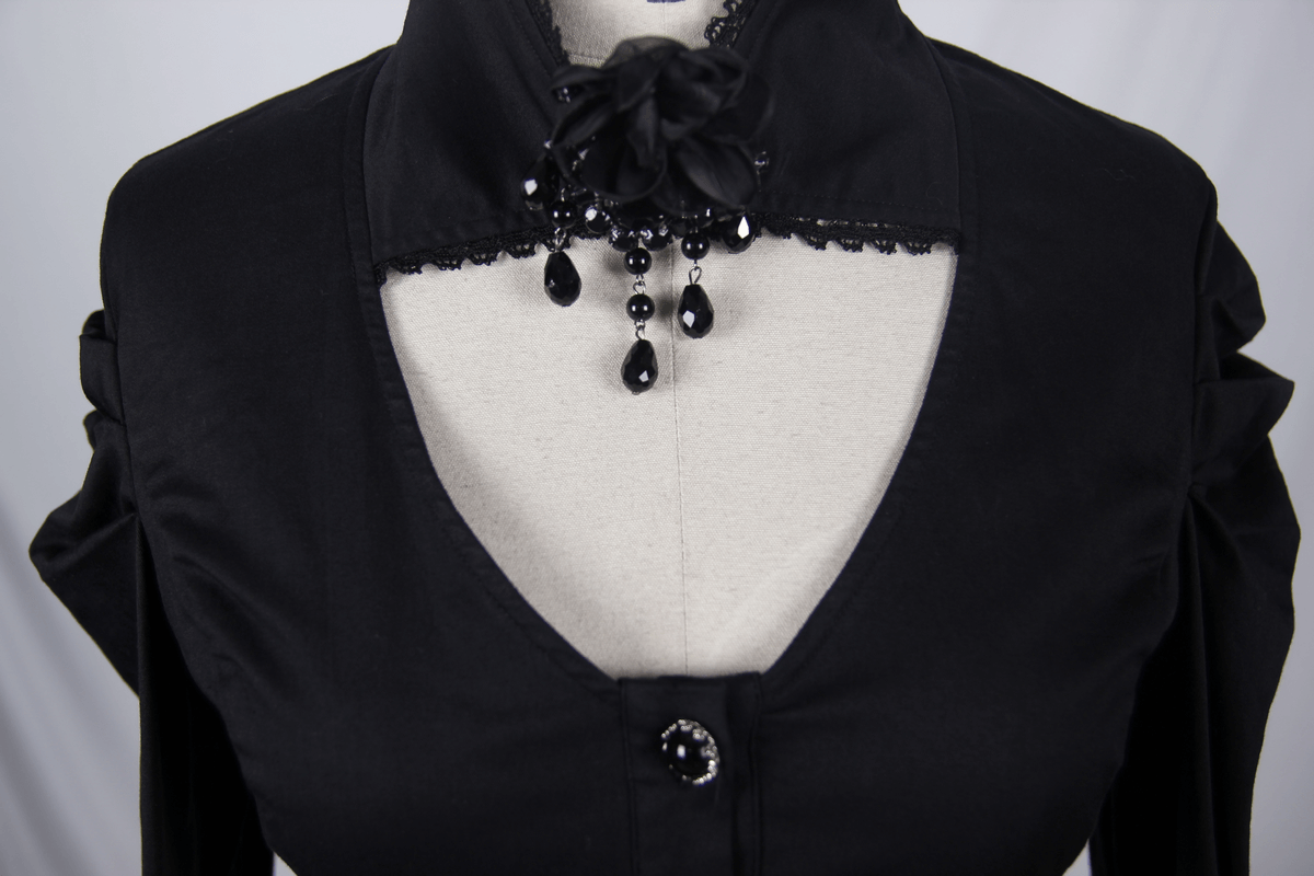 Elegant women's black gothic shirt featuring a flower pendant brooch and unique stand collar.
