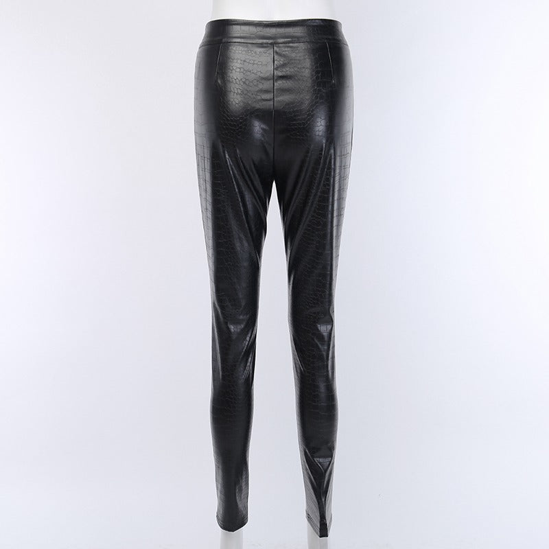 Elegant black high-waist faux leather skinny pants with snake print, perfect for rock or goth outfits.