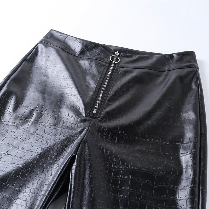 Elegant high waist faux leather pants with snake print and zip detail, perfect for a rock or goth outfit.