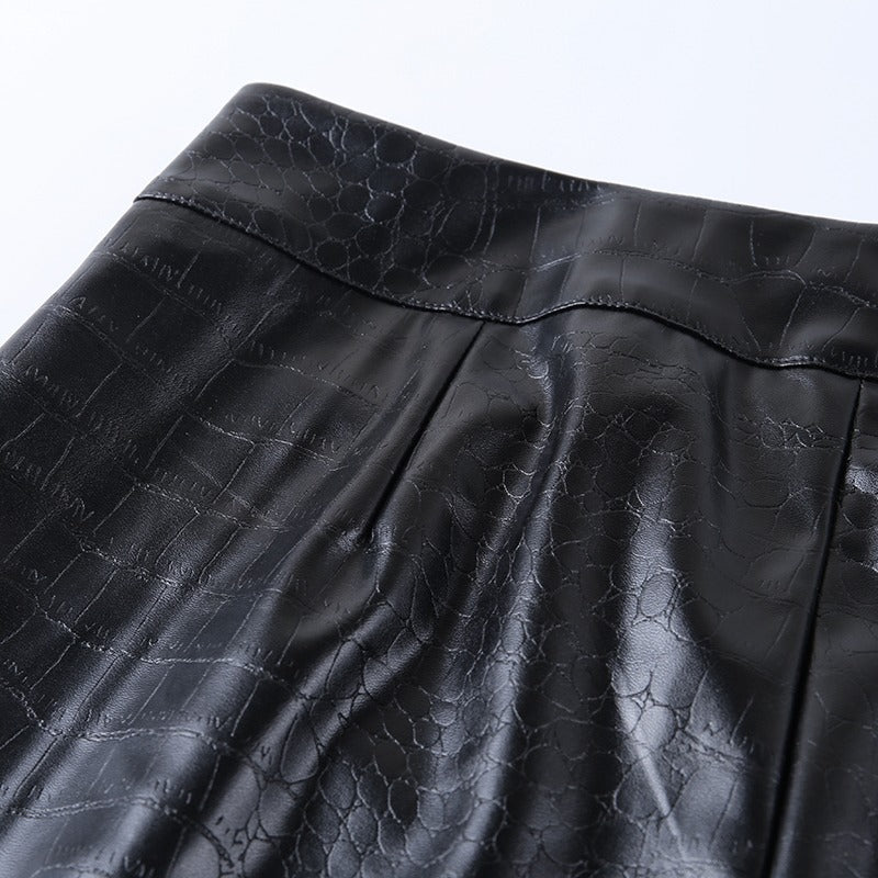 Close-up of elegant high waist faux leather pants with snake print texture, ideal for rock and goth styles.