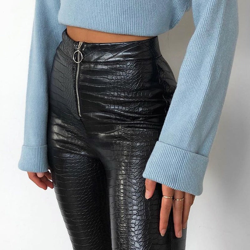 Elegant high waist faux leather skinny pants with snake print and Gothic zip, styled with a light blue top.
