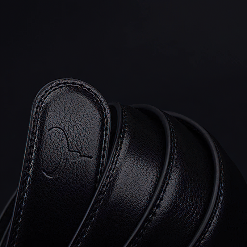 Close-up of an elegant black genuine leather belt, showcasing quality craftsmanship and a sleek design.