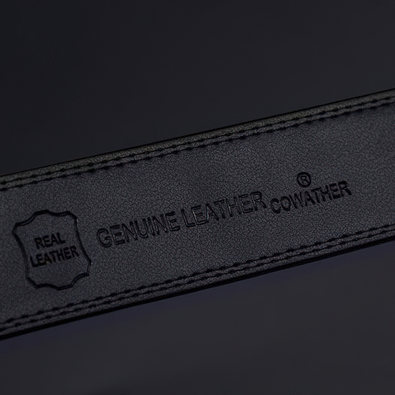 Close-up of a genuine leather belt showcasing the embossed logo and texture for luxury men's fashion.