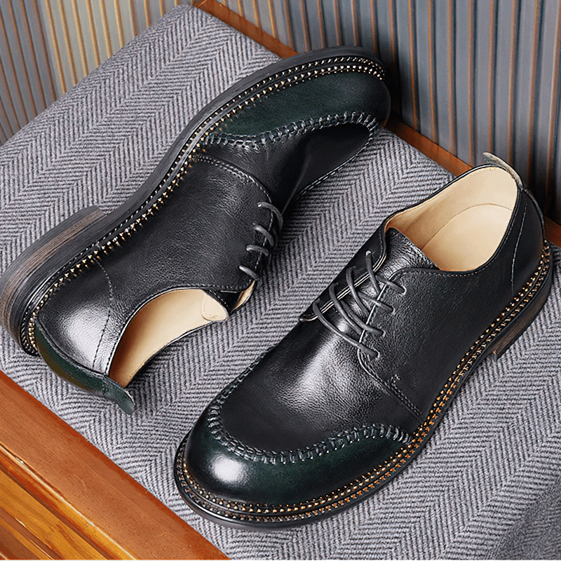 Elegant men's leather shoes in retro style on a textured surface, showcasing breathable lace-up design.