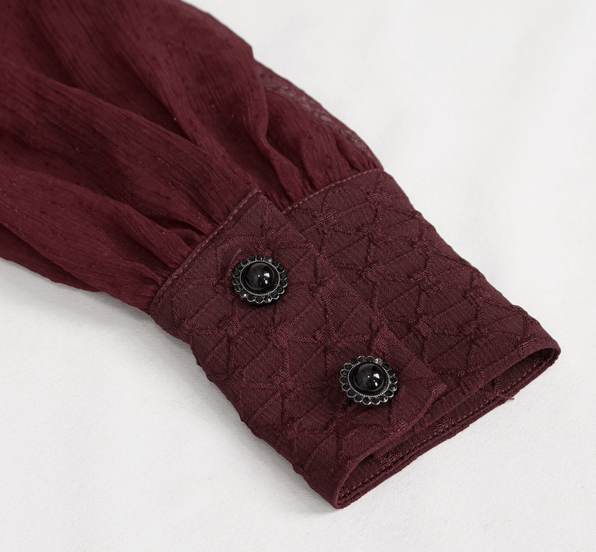 Close-up of burgundy shirt cuff with textured fabric and black buttons, showcasing elegant gothic style details.