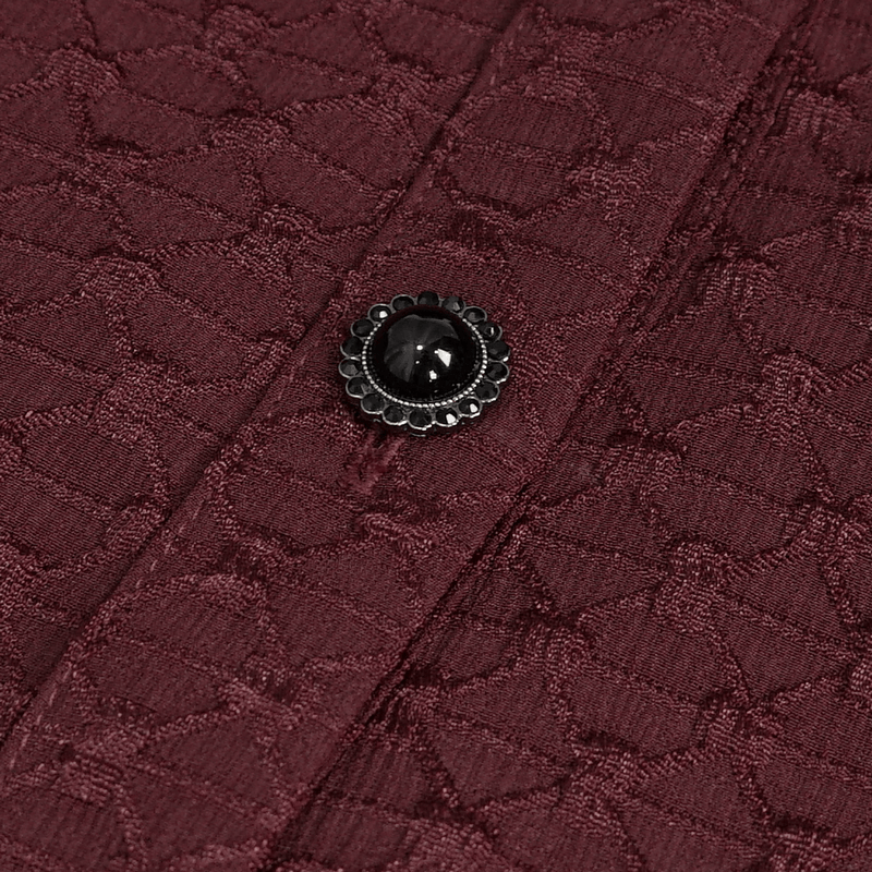 Close-up of maroon fabric with intricate texture and decorative black button for elegant off-shoulder shirt.