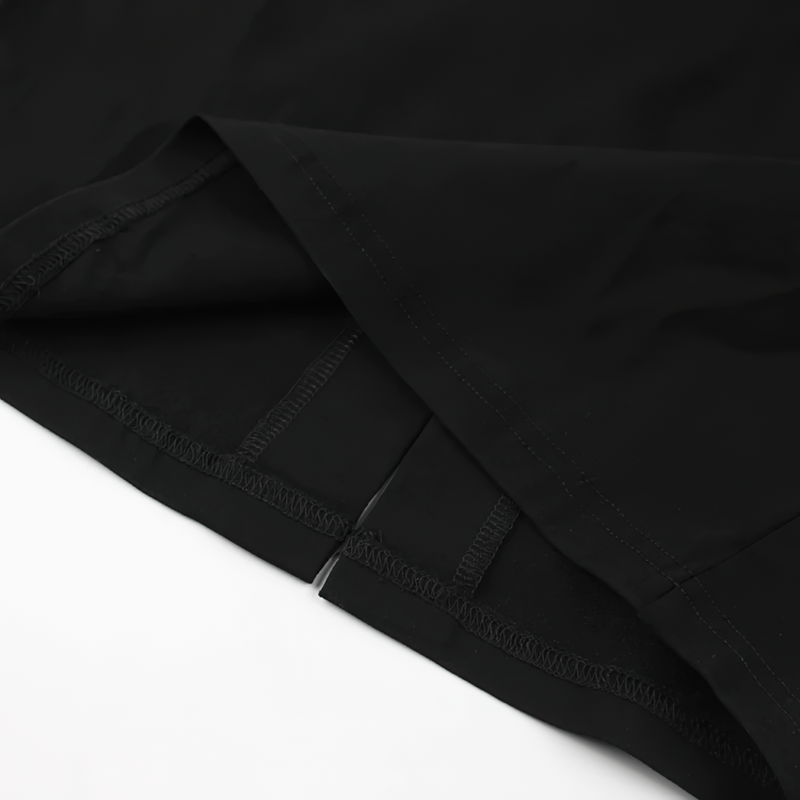 Close-up of the hem and stitching of an elegant black long dress, showcasing quality and style.