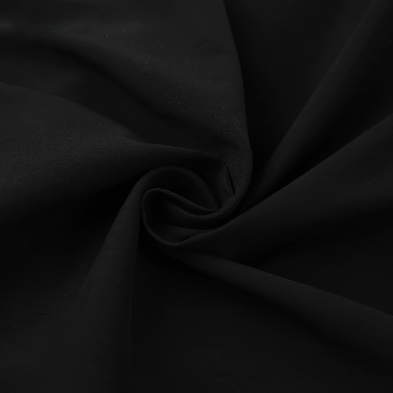 Close-up of luxurious black fabric, ideal for crafting elegant women's dresses and stylish outfits.