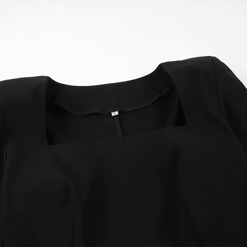 Close-up of the elegant neckline and fabric of the sexy women's long black dress, perfect for gothic style.