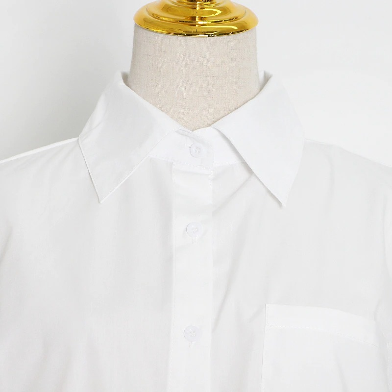 Close-up of an elegant white shirt collar and buttons, perfect for women's fashion outfits.