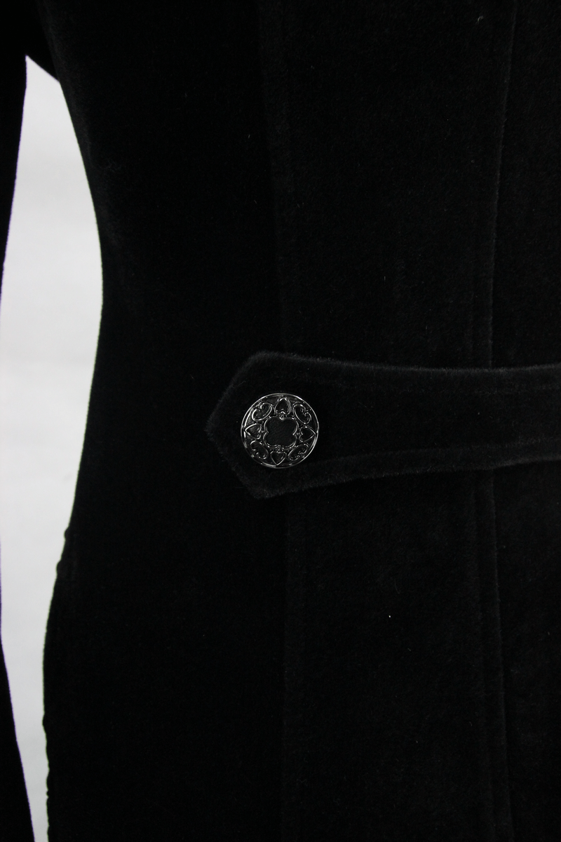Close-up of a black velvet coat with intricate button detail, perfect for an elegant gothic look.