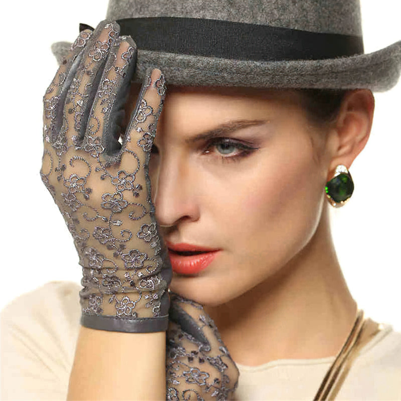 Elegant women's lace gloves with floral patterns, paired with a chic hat and earrings, perfect for a stylish night out.