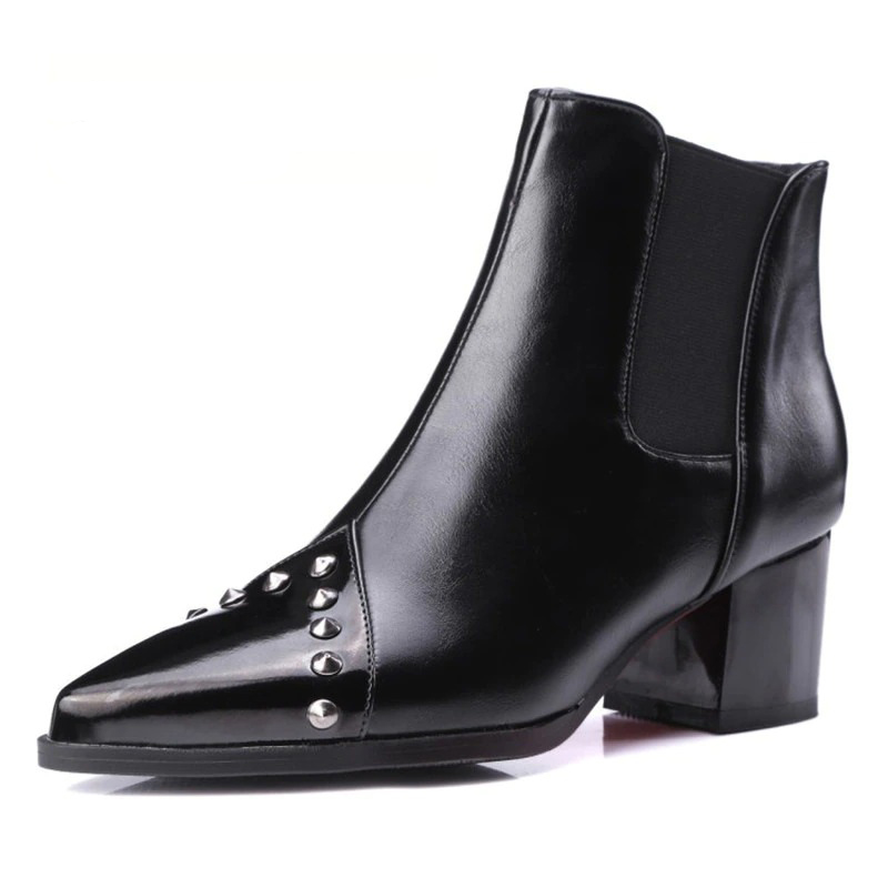 Elegant women's pointed black ankle boots with spikes and thick heels, perfect for casual or stylish looks.