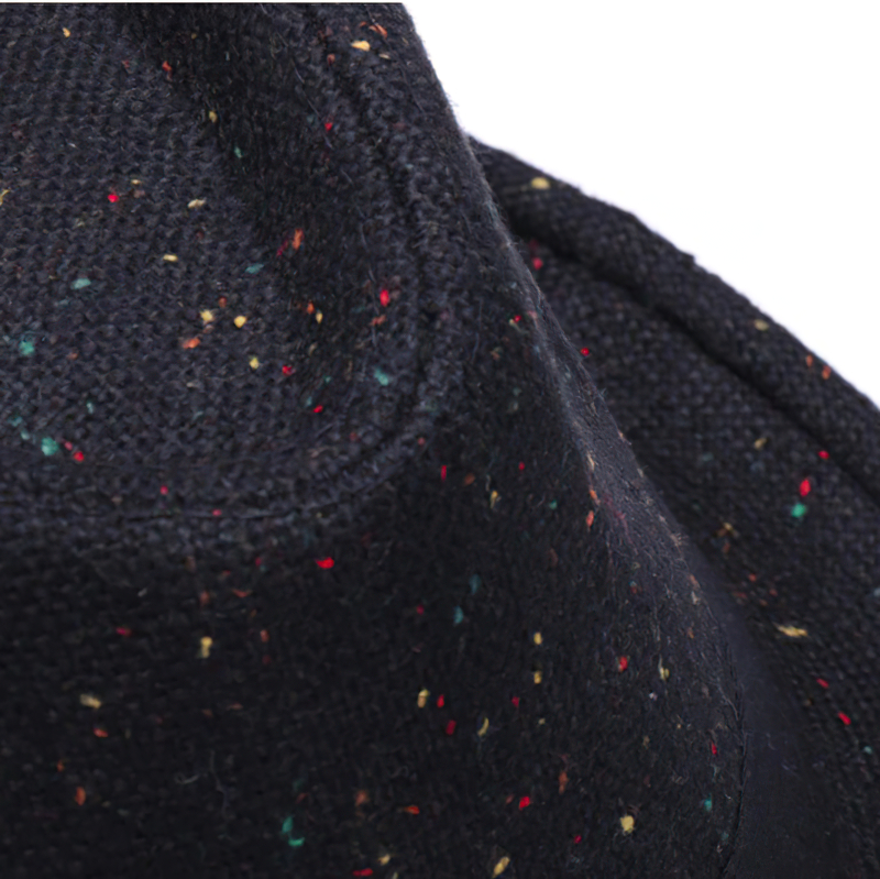 Close-up of an elegant woolen hat with colorful flecks, showcasing its texture and craftsmanship.