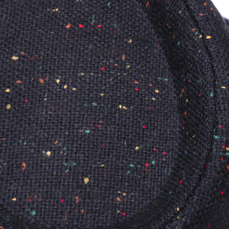 Close-up of stylish woolen hat fabric featuring colorful specks, perfect for adding elegance to your outfit.