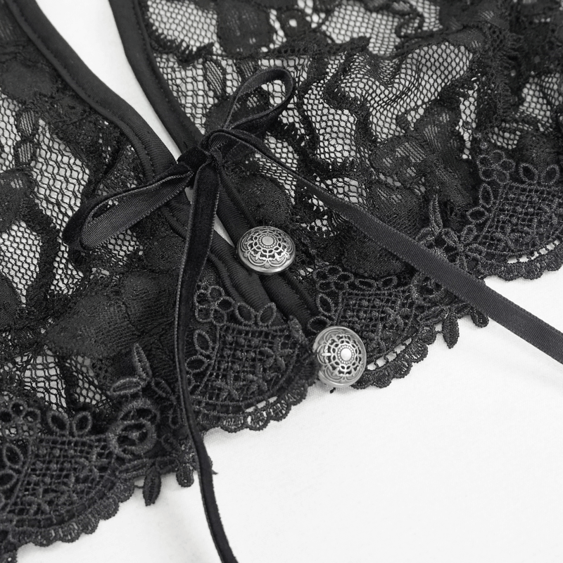 Close-up of elegant black lace detailing with buttons and ribbons on a gothic lingerie set.