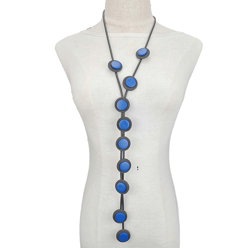 Ethnic long pendant necklace for women, featuring blue rubber discs on a black cord for a gothic style accessory.