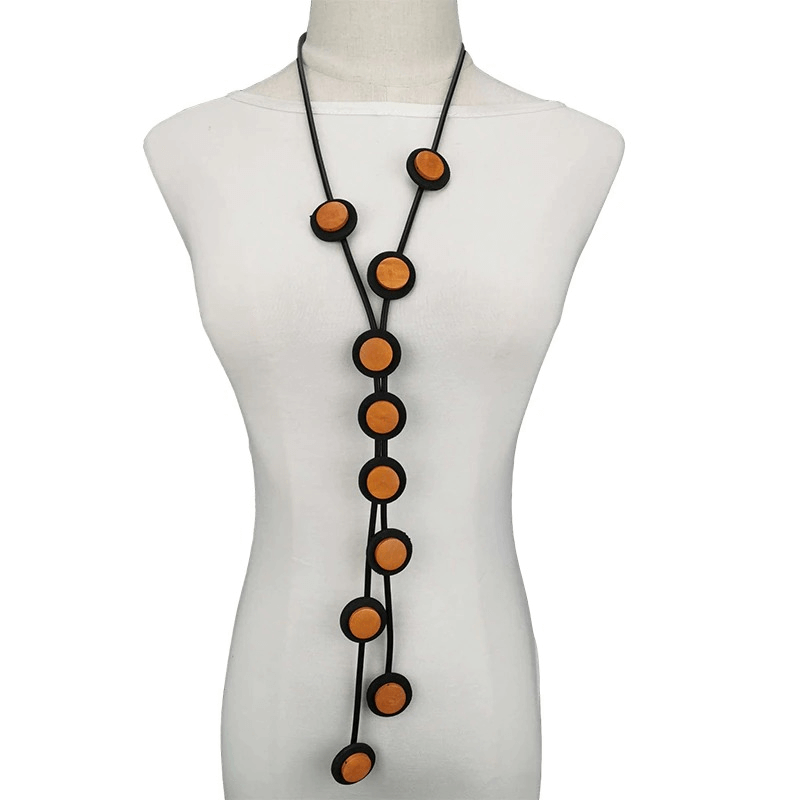 Ethnic long pendant necklace for women featuring a unique rubber design with bold orange accents.