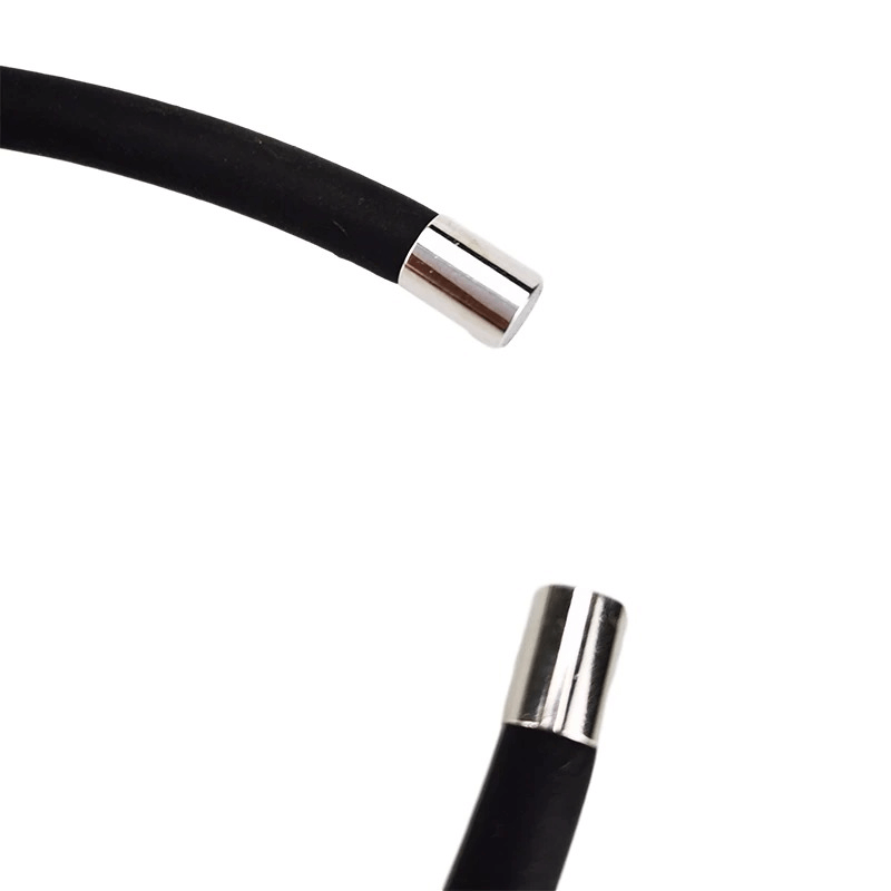 Close-up view of the ends of a handmade silicone choker with silver metallic tips.