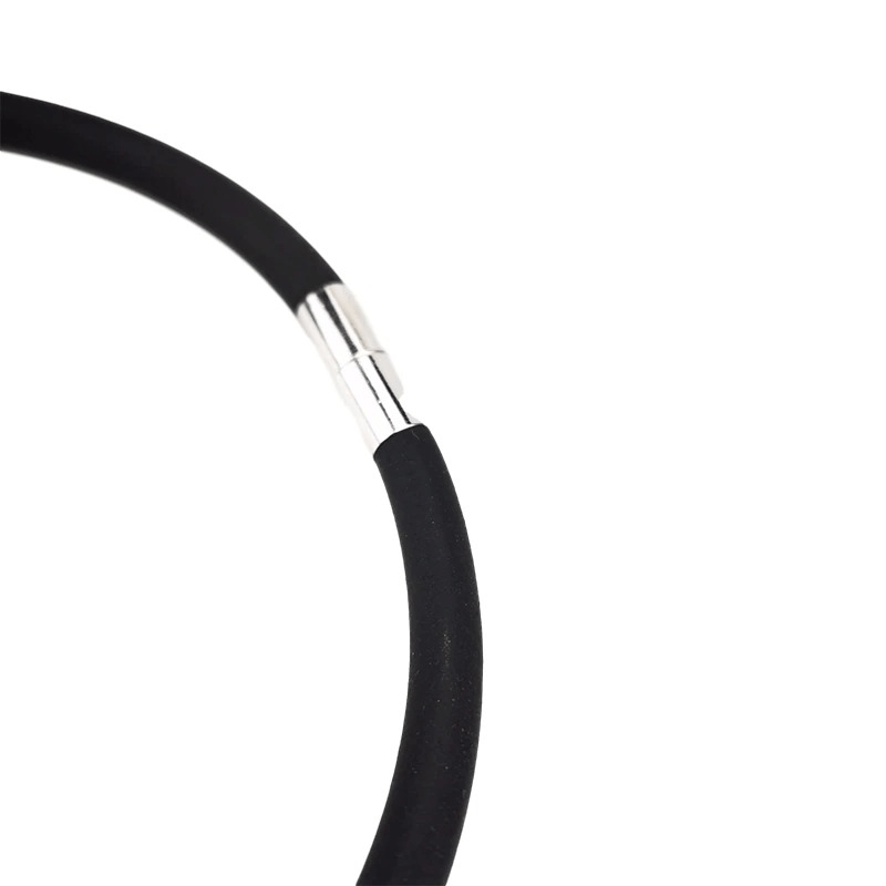 Close-up of a black silicone choker necklace with a silver clasp, showcasing its handmade design and elasticity.
