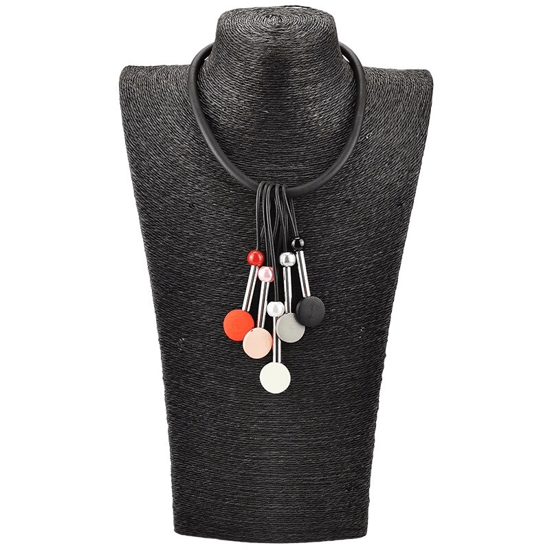Handmade ethnic necklace for women with multicolor beads on a black display bust.