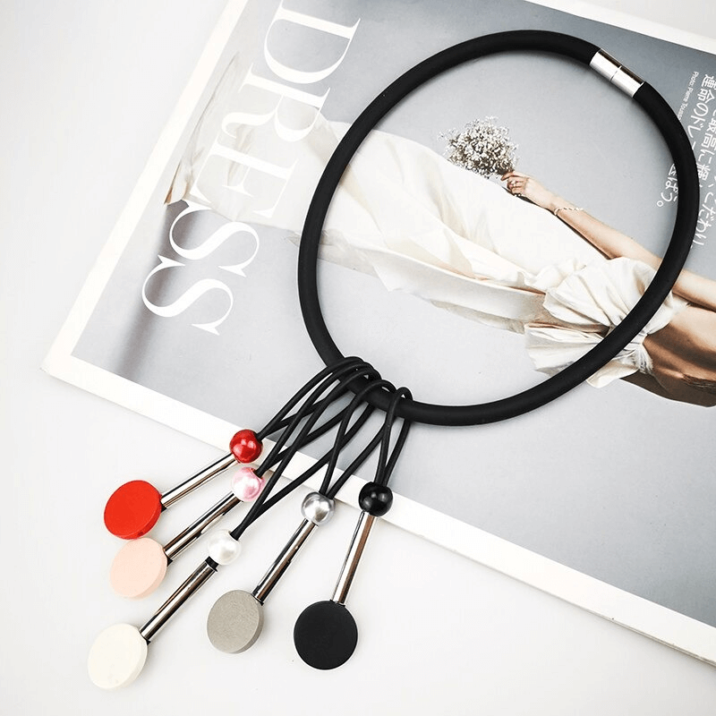 Handmade ethnic choker necklace with multicolor beads displayed stylishly on a magazine.