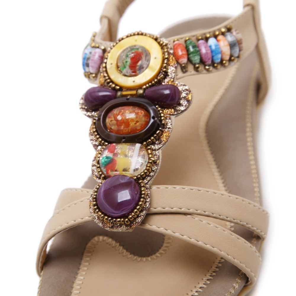 Close-up of ethnic style women's beaded sandals with colorful stone decorations and a soft PU leather base.