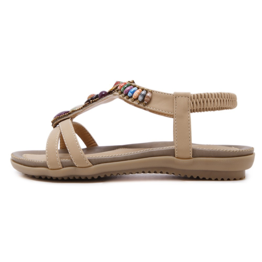 Ethnic style women's beaded sandals in beige with decorative stones and elastic closure, perfect for summer outfits.