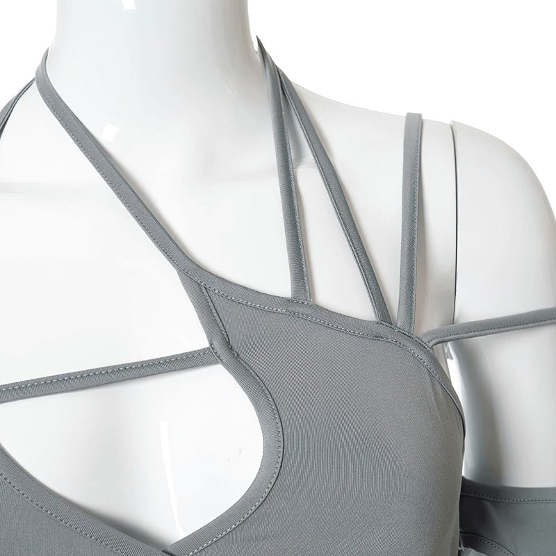 Close-up of a women's sexy cut out long sleeve crop top with asymmetrical design in gray.